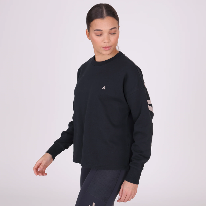 Person wearing a black sweatshirt with a logo on a white background
