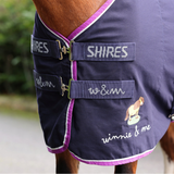 Shires horse rug with embroidery on a blurred background