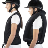 Person wearing a black equestrian vest and helmet on a white background