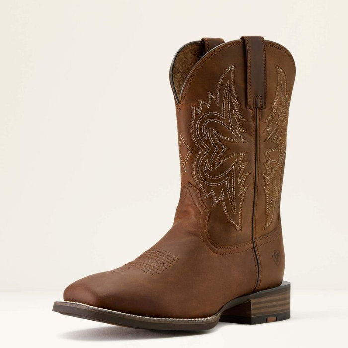 Ariat Men's Western Big Rig Wide Square Toe Cowboy Boot Variant Colour Distressed Brown. Western squared toe boot in brown with decorative stiching on the side on light cream background.