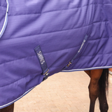 Close-up of a purple Shires horse rug on a horse.