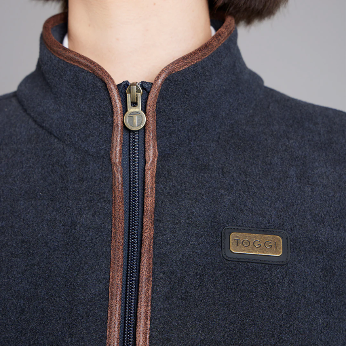Navy blue jacket with brown zipper and 'Toggi' brand logo on a grey background