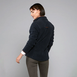 Woman wearing a navy blue jacket on a grey background
