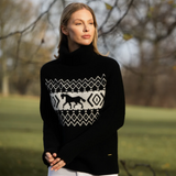 Woman wearing a black turtle neck sweater in an outdoor setting