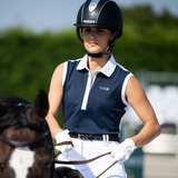 Rider wears Toggi Ladies Haymarket Sleeveless Polo Shirt in Navy/White