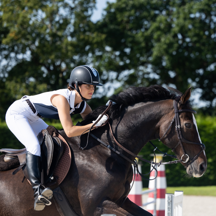 Show jumper wears Toggi Ladies Haymarket Sleeveless Polo Shirt in Navy/White