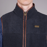 Dark gray gilet with brown zipper and plaid shirt underneath on a grey background