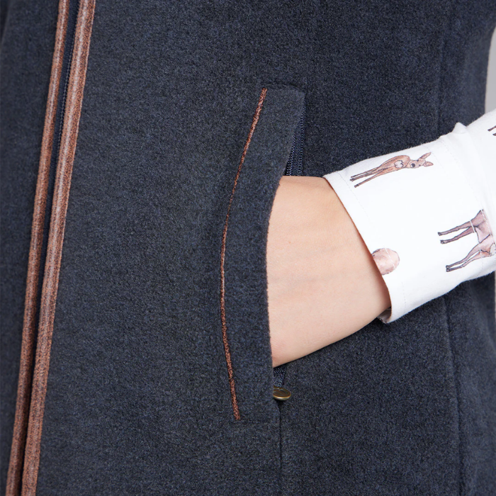 Close-up of a dark blue fleece gilet with a hand in the pocket.