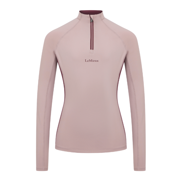 LeMieux AW26 Young Rider Classique Base Layer Variant Colour Wild Rose.
A women's long-sleeve quarter-zip athletic top in a dusty rose pink color, featuring a dark burgundy zipper and collar trim, with the 'LeMieux' brand name printed on the chest.