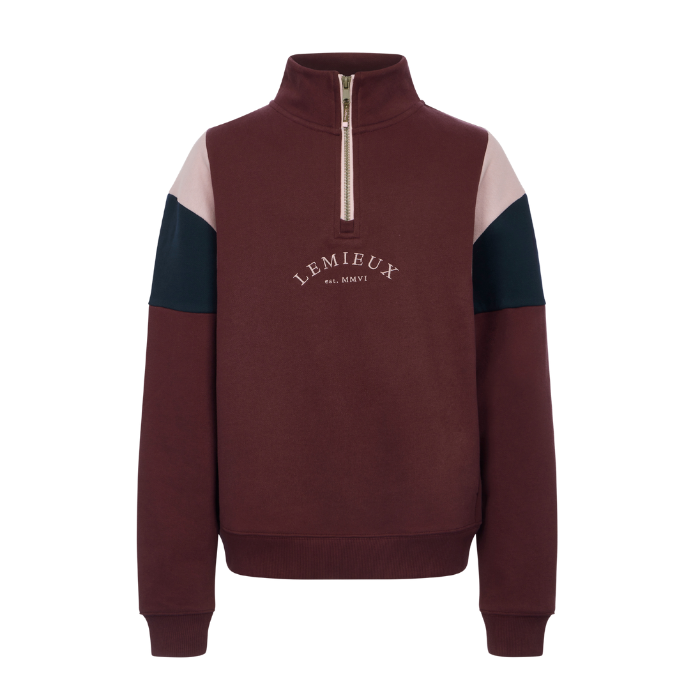 LeMieux AW26 Young Rider Viola Quarter Zip Sweat Variant Colour Bramble.
A quarter-zip sweatshirt by Lemieux in bramble, featuring light pink color-blocked shoulder panels and part navy sleeve panels, with a pink zipper and white embroidered logo on the chest. On white background.