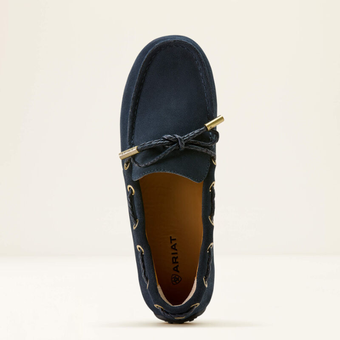 Navy blue loafer shoe with gold accents on a light beige background