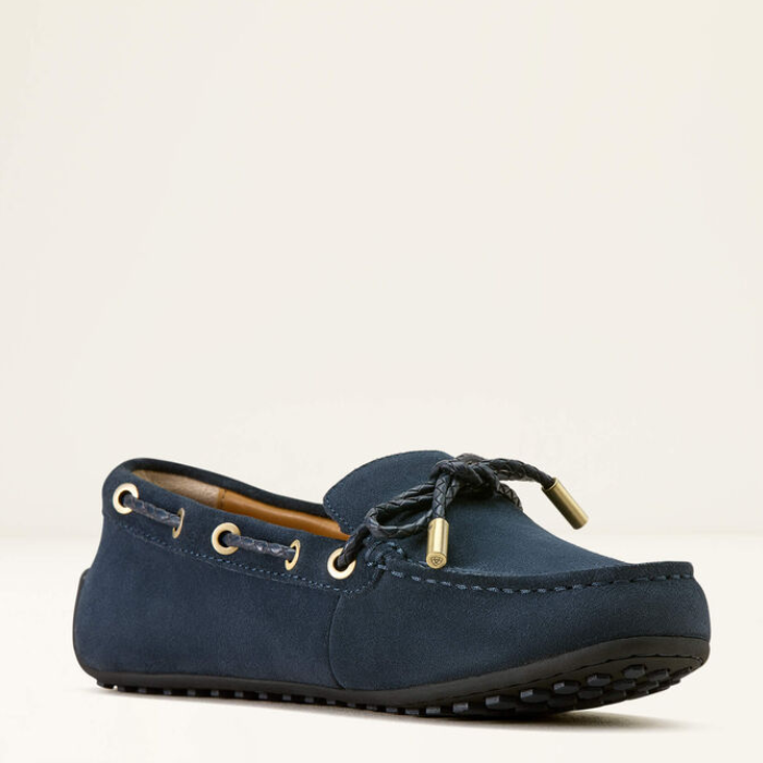 Navy blue loafer shoe on a light beige background