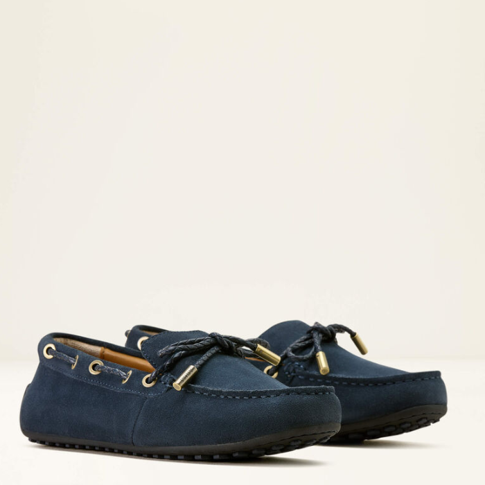 Pair of navy blue loafers on a light beige background