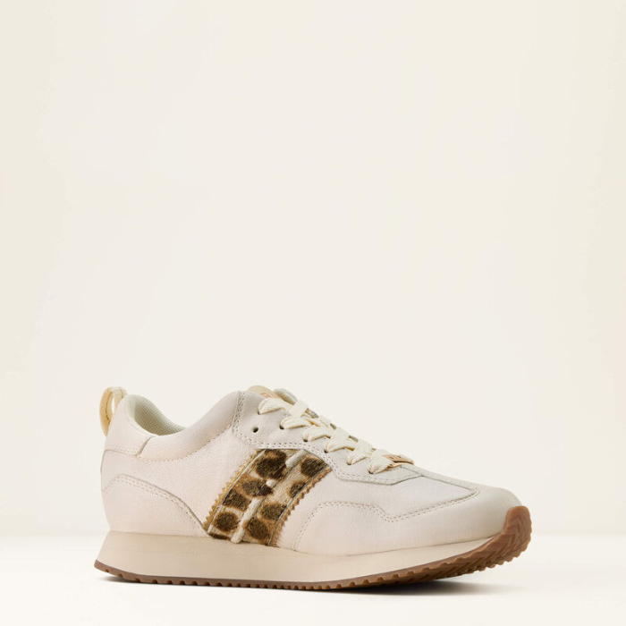 White sneaker with leopard print accents on a beige background