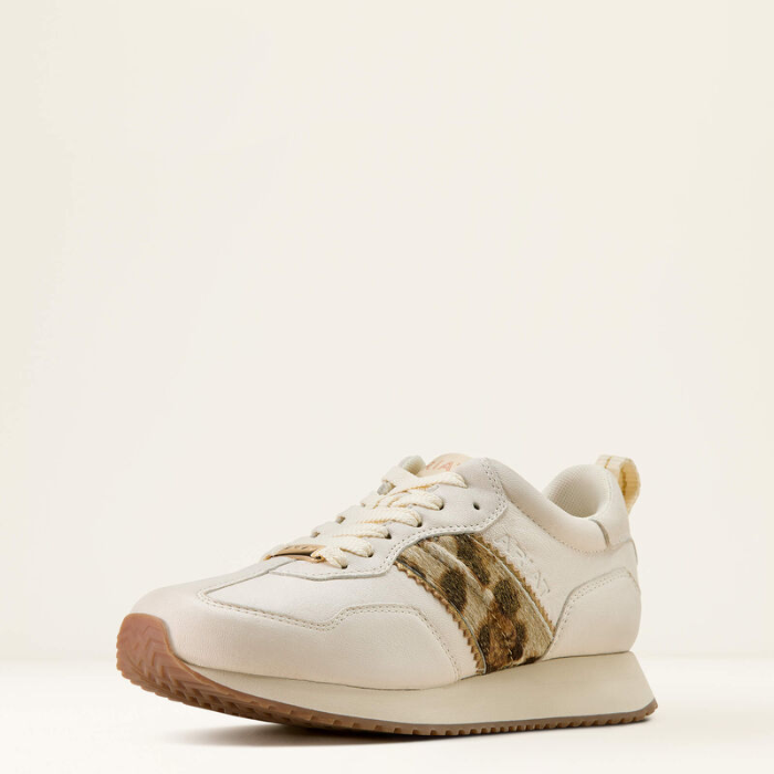 White sneaker with a brown accent on a light beige background