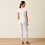 Person wears white riding breeches on a beige background