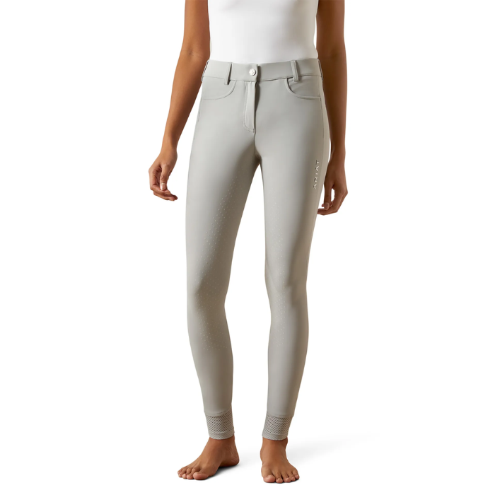 Light gray riding pants worn by a person on a white background