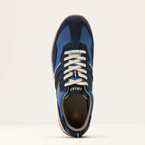Blue trainer with white laces on a beige background