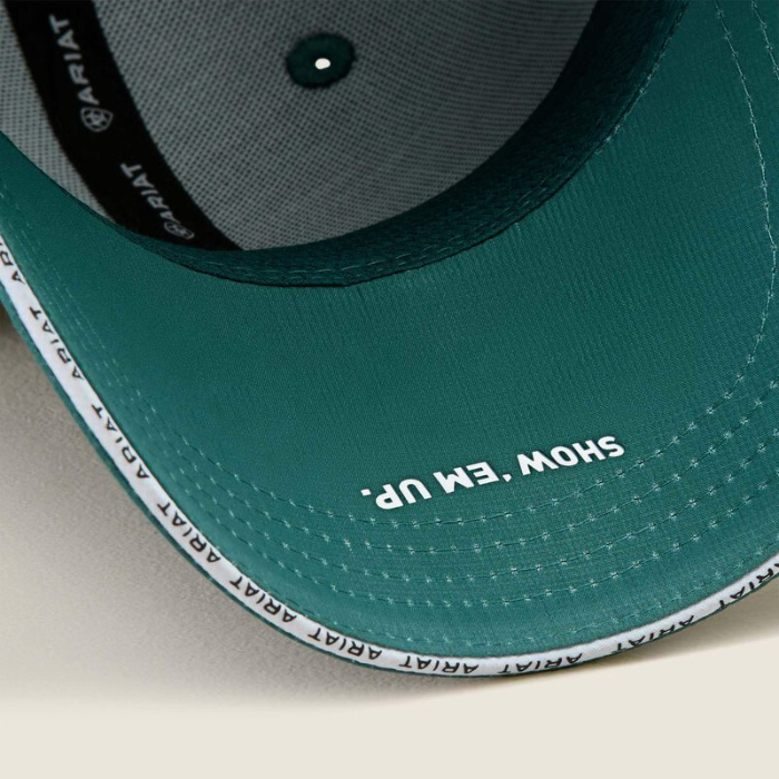 Green baseball cap with SHOW 'EM UP printed on a beige background