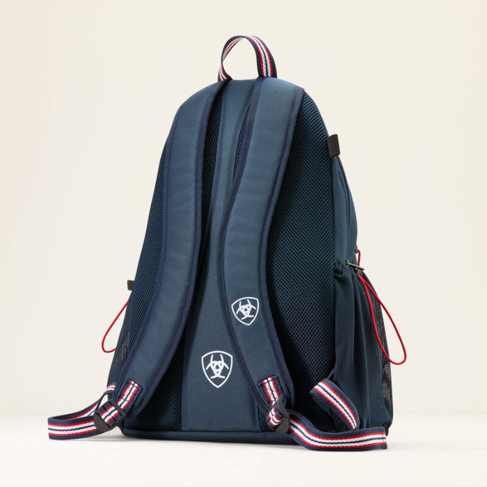 Navy blue backpack with red and white accents on a beige background