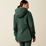 Person wearing a green raincoat on a beige background