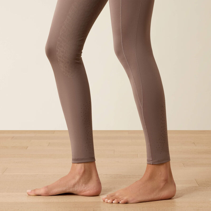 Brown riding leggings on a neutral background