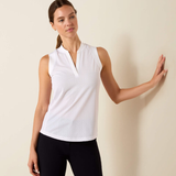 Female model with white sleeveless v neck top on cream background front view