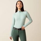 Soft green base layer with green leggings on a beige background