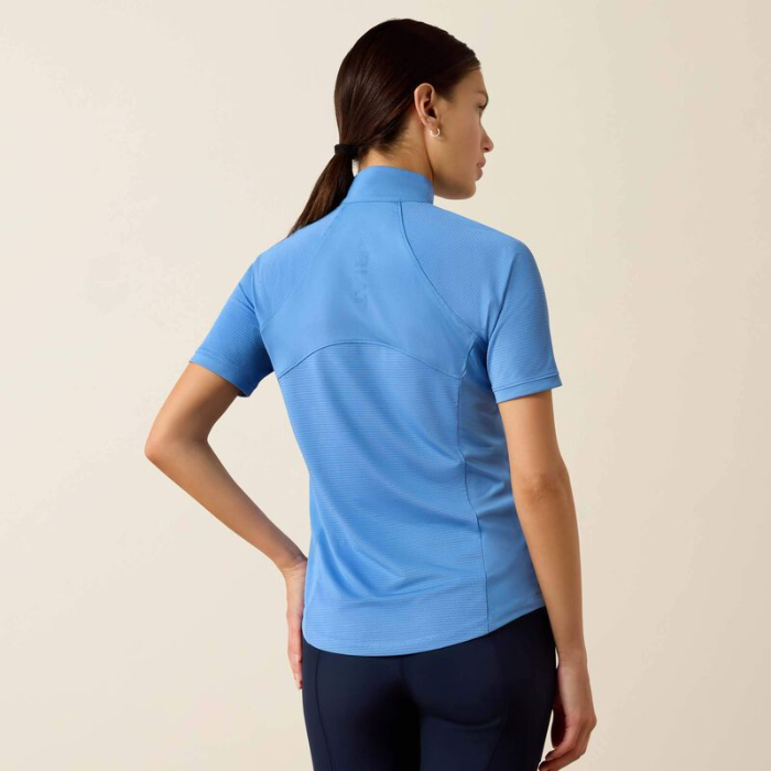 Woman wearing a blue short-sleeve shirt on a beige background