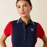 Woman wears navy and red polo t-shirt on a plain background