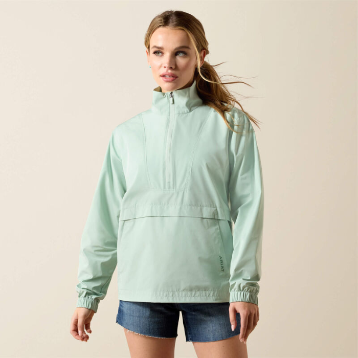 Woman wearing a light green jacket on a beige background