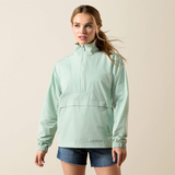 Woman wearing a light green jacket on a beige background