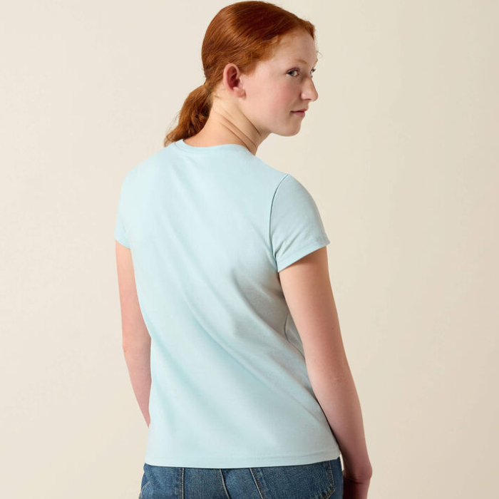 Girl wears pale blue t-shirt on a beige background