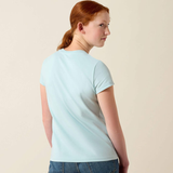 Girl wears pale blue t-shirt on a beige background