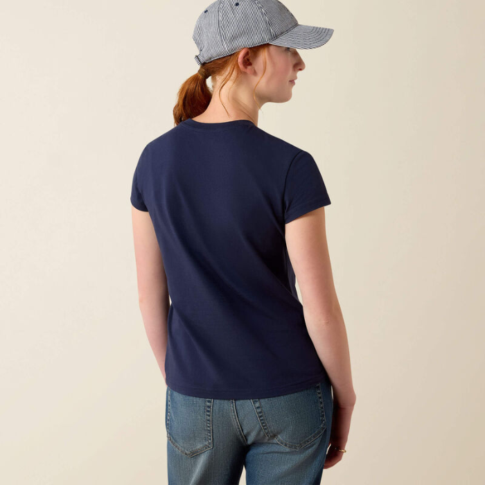 Girl wears navy blue t-shirt on a beige background