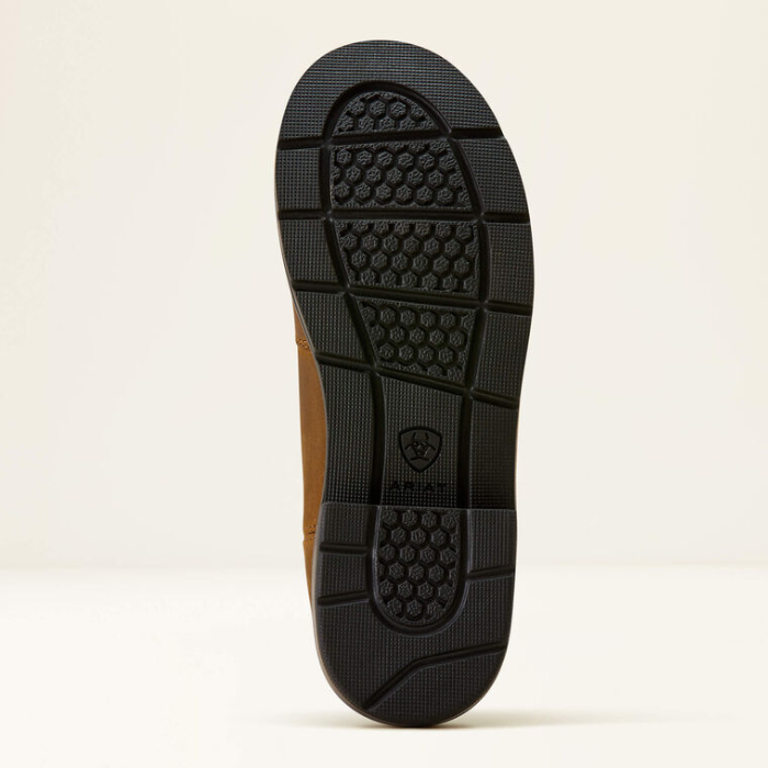 Close-up of a shoe sole with a brand logo on a beige background
