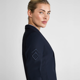 Woman wearing a navy blue blazer on a light grey background