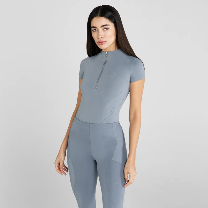 Woman wearing a blue athletic outfit on a light grey background