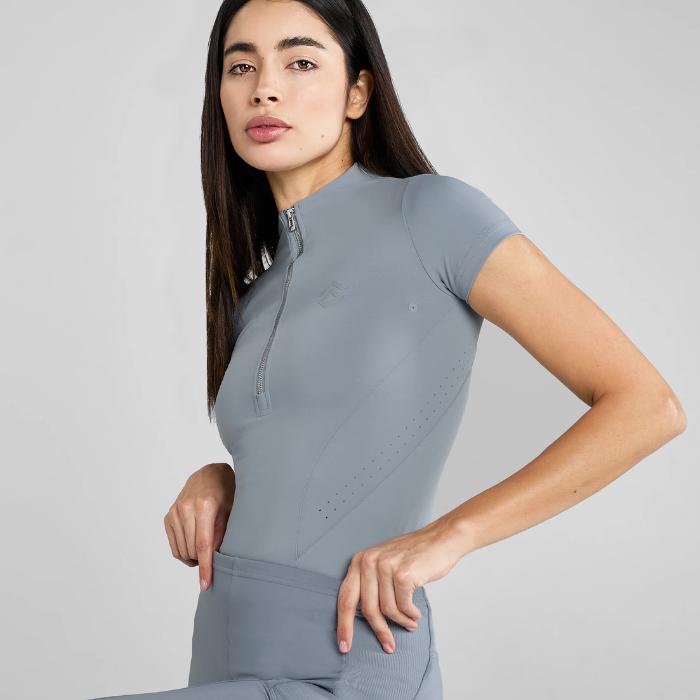 Woman wearing a blue athletic outfit on a light grey background