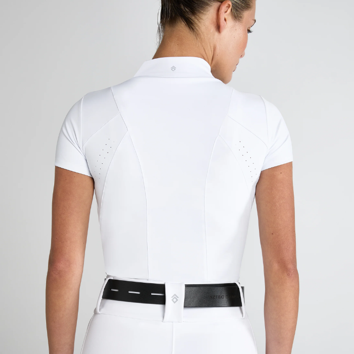 Person wearing a white base layer and breeches with black belt on a plain background