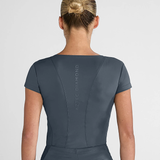 Person wearing a dark grey outfit with 'Aztec Diamond' branding on the back against a light grey background