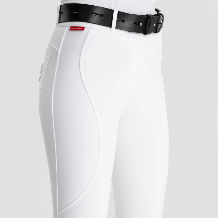 White riding breeches with a black belt on a white background