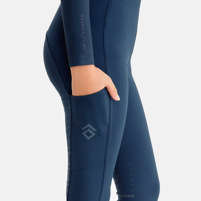 Close-up of navy riding legging with a pocket on a grey background