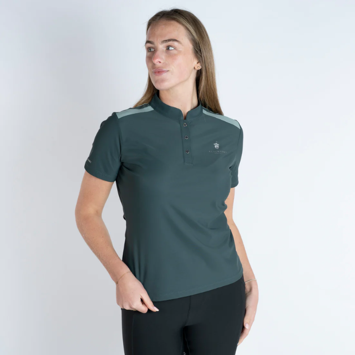 Woman wearing a teal polo shirt with a small logo on a white background