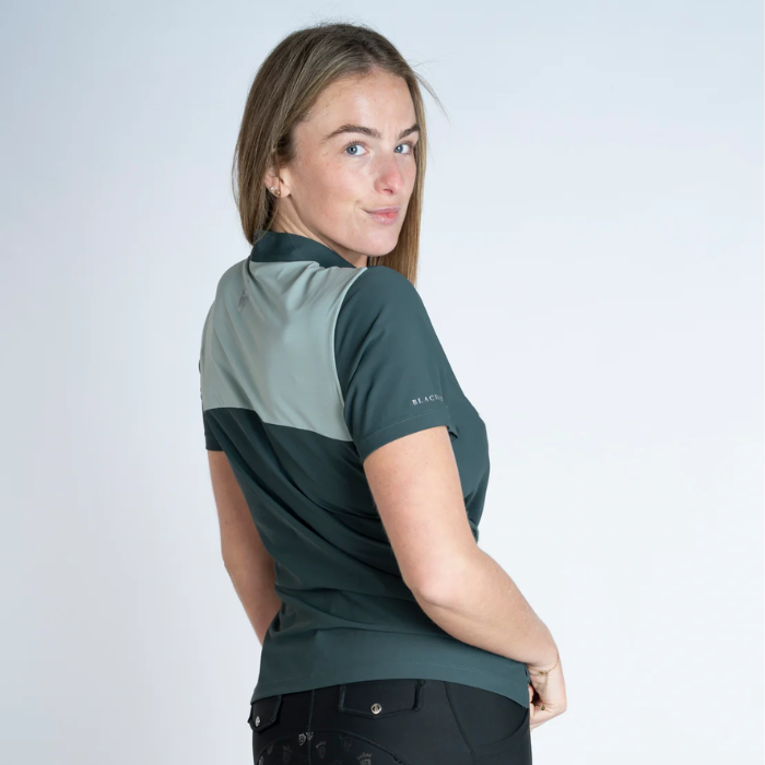 Woman wearing a green and gray polo shirt on a white background