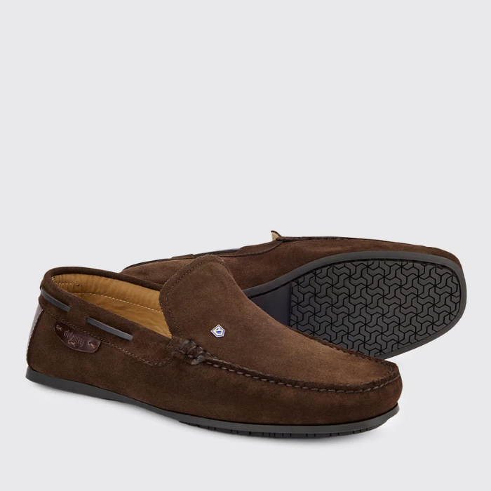 Brown suede loafers on a light grey background