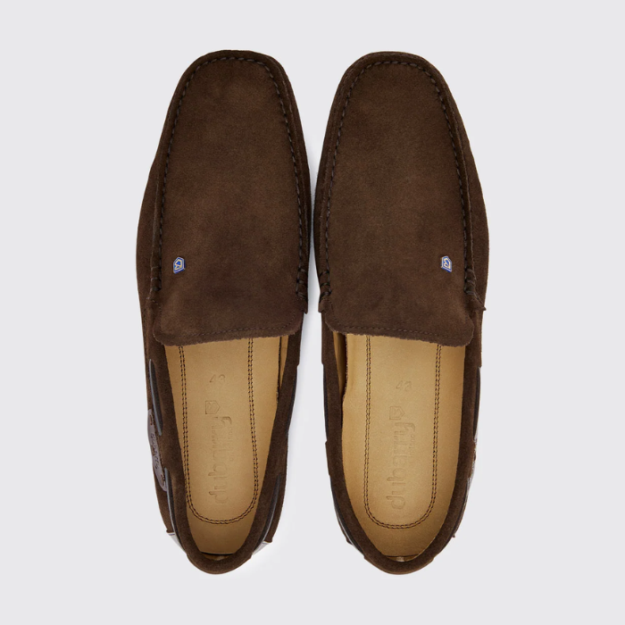 Pair of brown suede loafers on a light grey background
