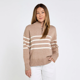 Woman wearing a brown sweater with white stripes on a white background