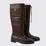 Pair of brown leather boots with a strap on a light grey background