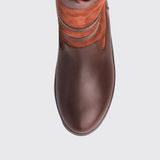 Brown leather boot with orange accents on a light grey background